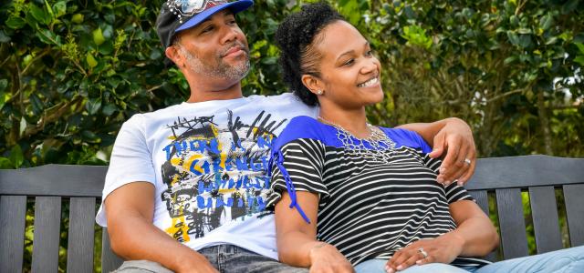 man in white crew neck t-shirt sitting beside woman in black and white stripe shirt by LaShawn Dobbs courtesy of Unsplash.