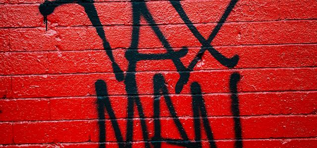 red and black brick wall by Jon Tyson courtesy of Unsplash.